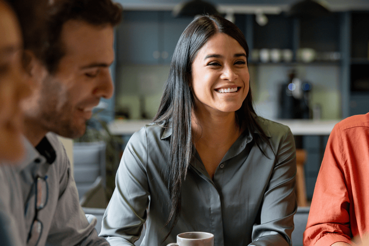 A woman smiling with a group of colleagues