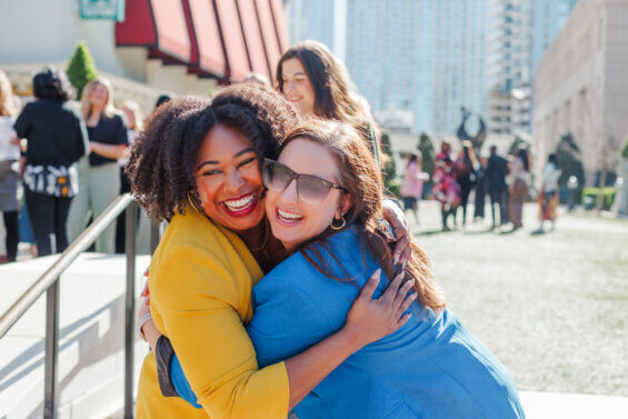 Two women hugging at a staff retreat