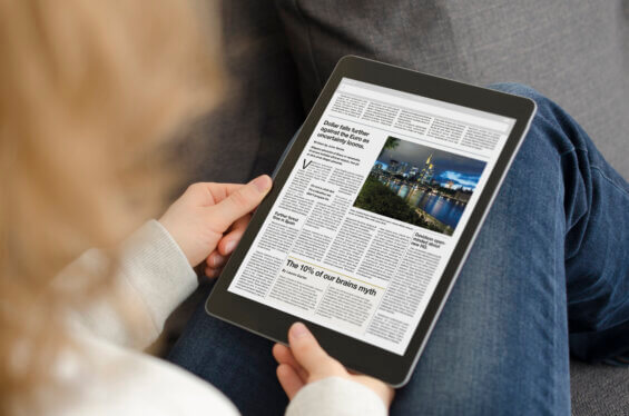 Women reading a news article on ad equivalency on an iPad