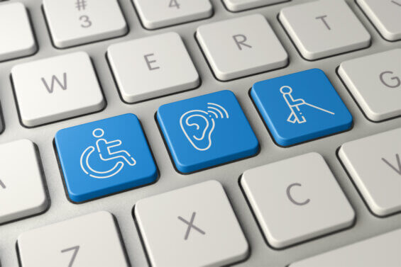 Keyboard showcasing ADA-compliant marketing with three blue keys: one with a wheelchair-accessible icon, one with the deaf icon, and one with the blind icon.