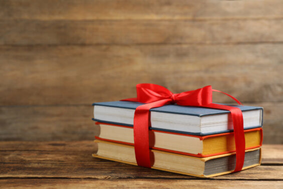 Three books wrapped in red ribbon