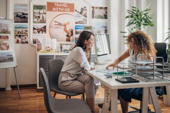 Woman speaking with a travel agent in an office