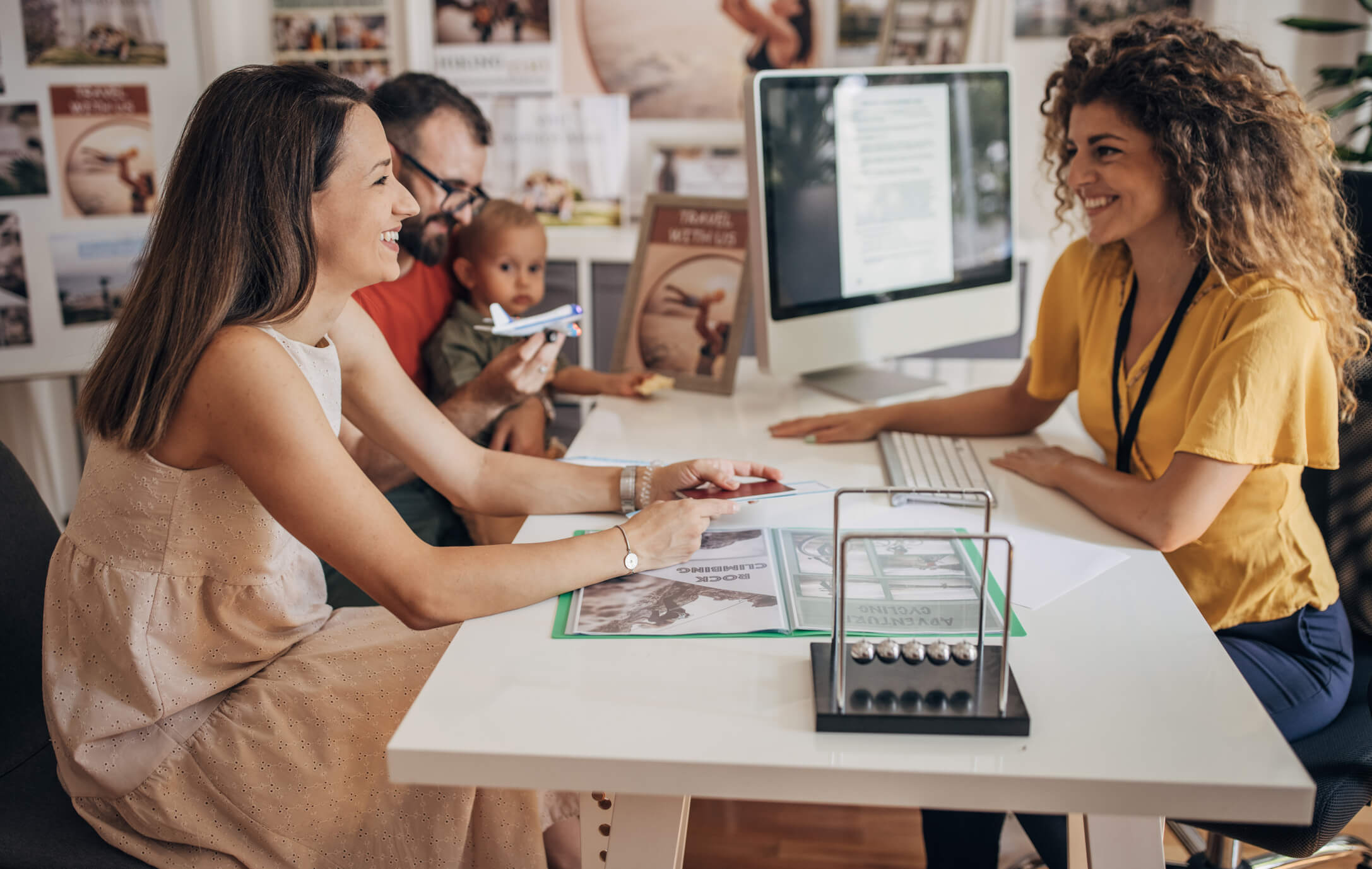 Woman working a tourism job helping a family plan a trip