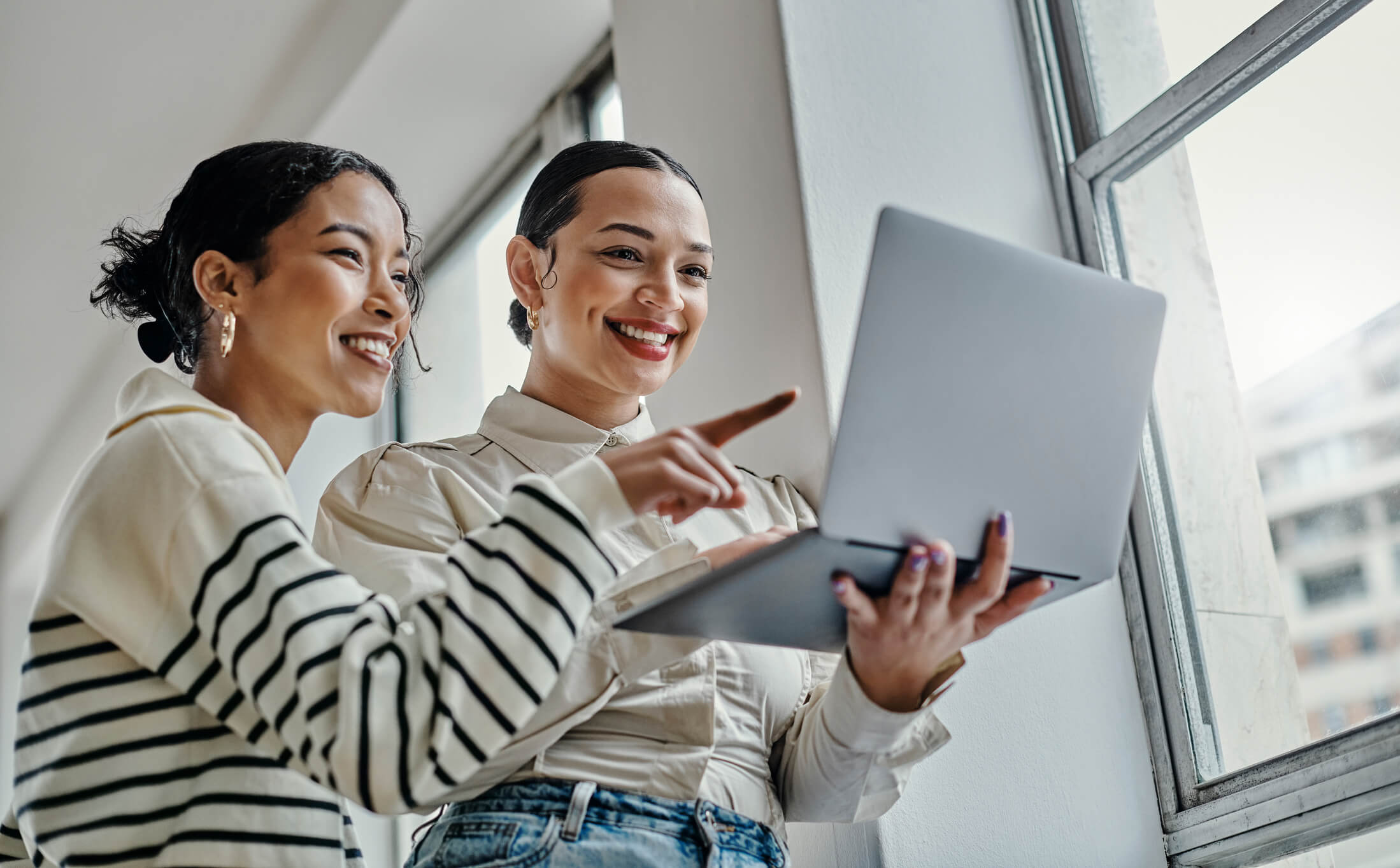 Two women working on a social media marketing strategy