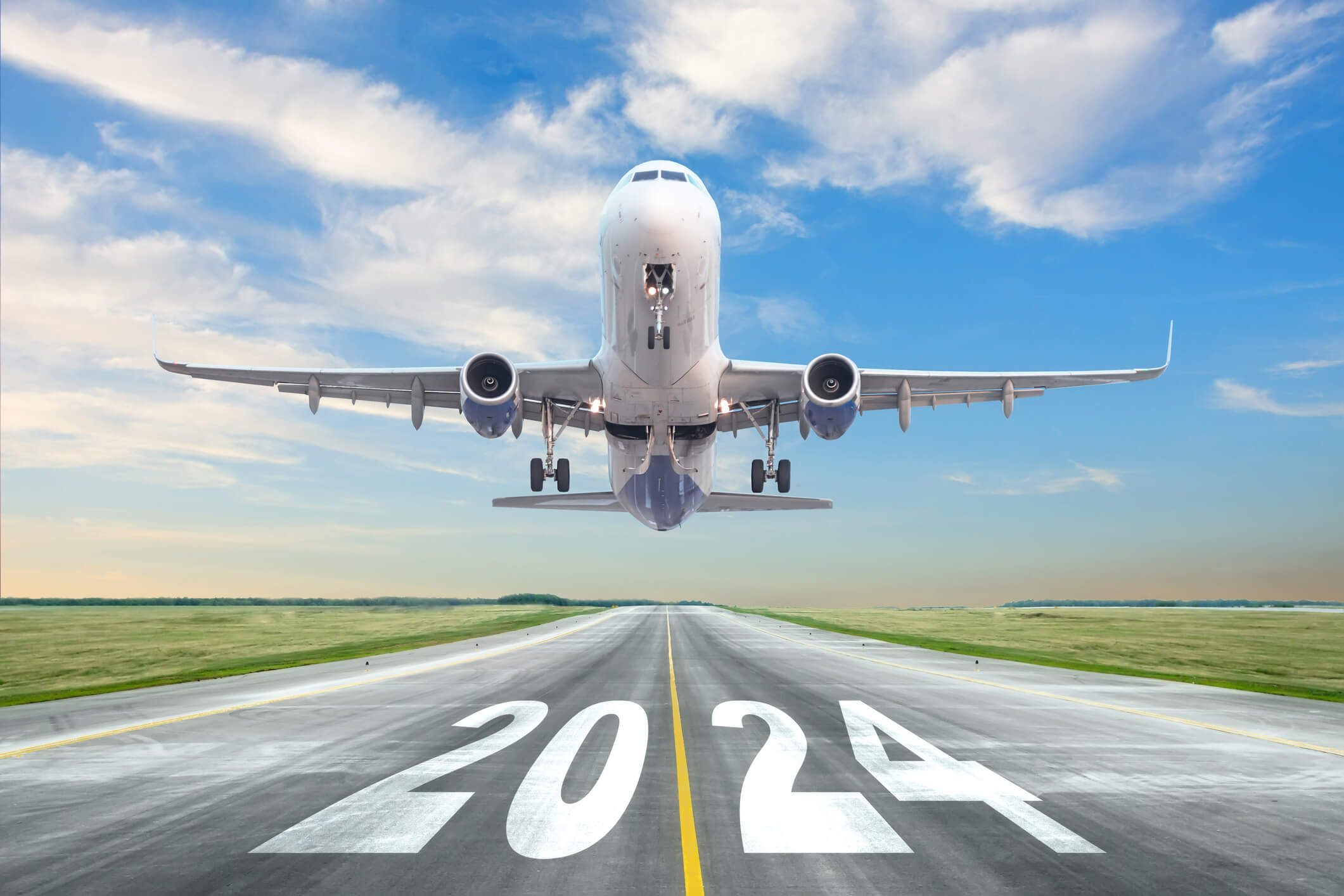 Inscription on the runway 2024 surface of the airport road yellow line take off airplane. Concept of travel in the new year, holidays