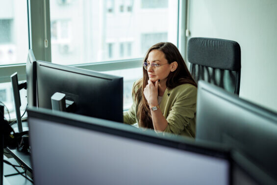 Woman looking at a computer, identifying and fixing economic development website mistakes