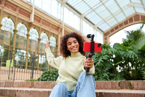 Influencer recording herself in a trains station.