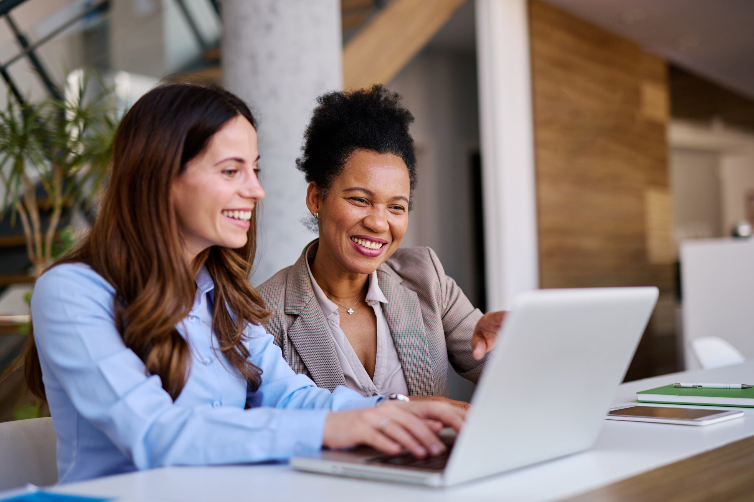 Two women discussing website accessibility at a desk
