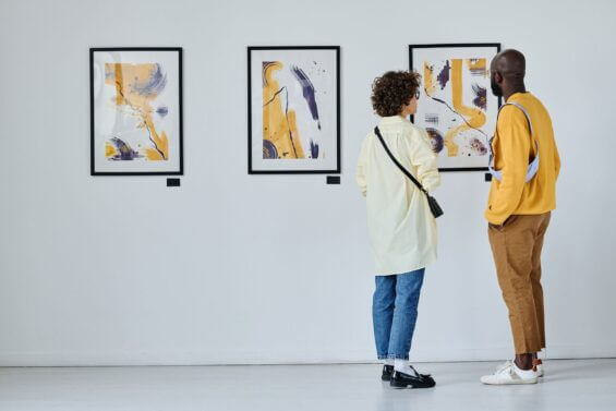 young couple standing and watching modern art